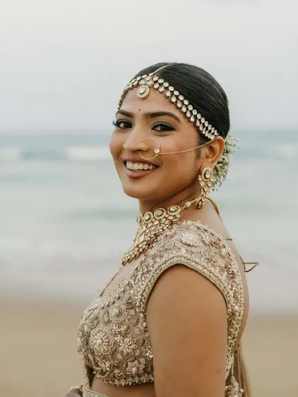 A happy bride enjoying her beach wedding. The look is fresh, light, and perfect for an outdoor daytime ceremony.