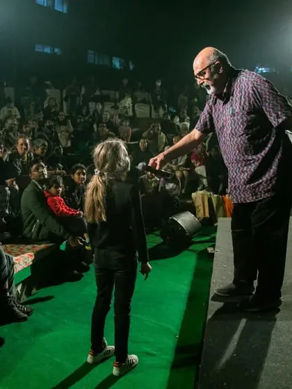 The festival director engages with a young audience member on stage. We believe in making theatre accessible and fun, and these interactive moments are a highlight for both the audience and our team.