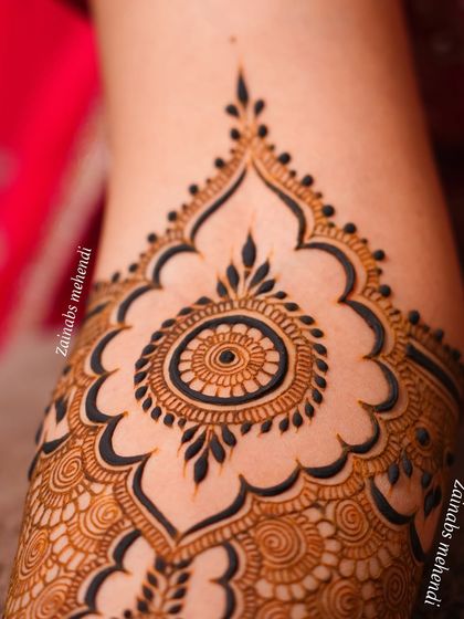 A close-up of the beautiful mandala motif on Arsha's arm, showcasing the clean lines and symmetry.