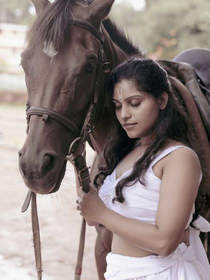A female warrior concept shoot. These images showcase dynamic action poses, including mid-air shots with a bow and arrow, and serene moments with a horse, all set against a dramatic, smoky backdrop.