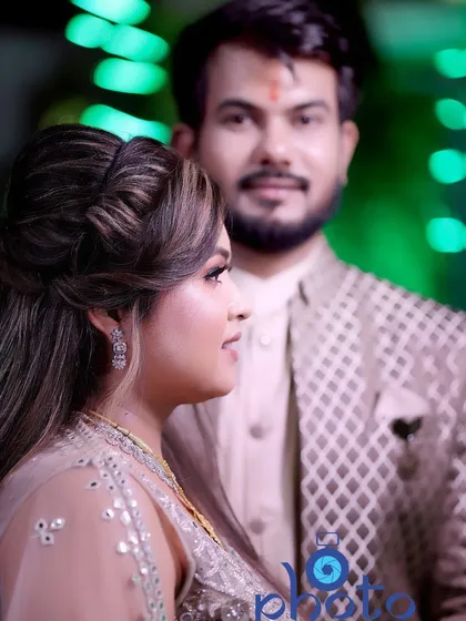 A portrait from an engagement ceremony, with the bride in sharp focus and the groom softly blurred in the background. This technique creates depth and highlights the bride's expression.