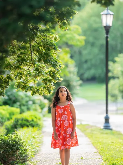 A thoughtful portrait of my daughter. The natural frame created by the leaves adds a beautiful touch to this outdoor photo.