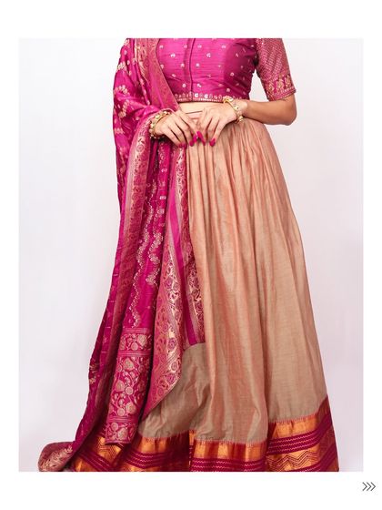 The full silhouette of the beige and magenta silk lehenga. It's an elegant and understated option for a wedding guest or for a family gathering.