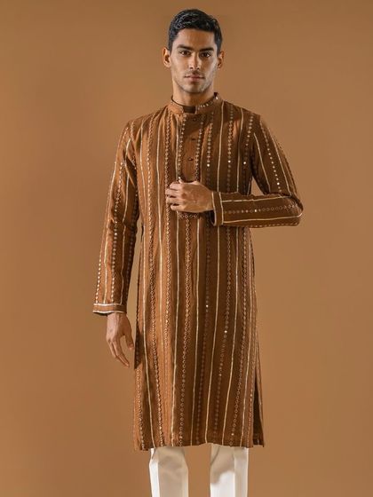A full-length view of the brown striped kurta, a dapper choice for any season. This bespoke piece is perfect for the man who values style and quality.