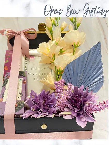 A luxury trunk box hamper wishing the recipient a 'Happy Married Life'. This open box gift is filled with beautiful flowers and thoughtful presents, perfect for a wedding or anniversary.