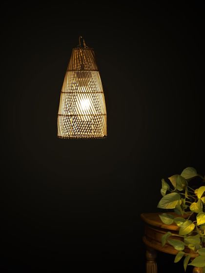 This lit conical bamboo lamp is perfect for focused lighting over a kitchen island or a small table. Its elongated shape draws the eye downward, creating an intimate and cozy ambiance.
