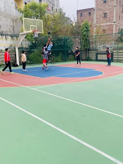 A player drives to the basket, showing determination.
