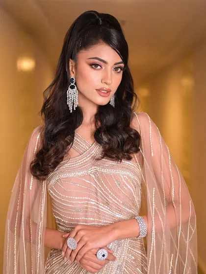 A confident and powerful pose. The high ponytail and sharp makeup give off a high-fashion vibe, perfect for the bride who wants to make a statement.