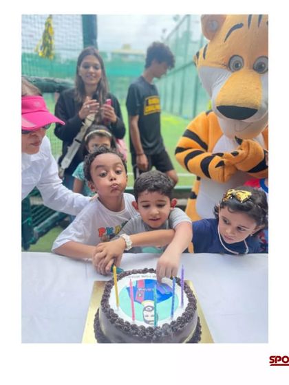 The birthday boy making a wish before cutting his cake, surrounded by friends and our mascot. I ensure the celebration is centered around making the birthday child feel like a champion.