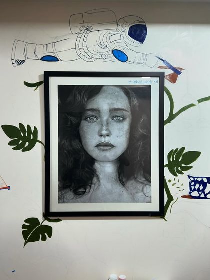 An update on my wall painting. You can see the mural developing around one of my favorite framed portraits. The astronaut and leaves are starting to come to life.