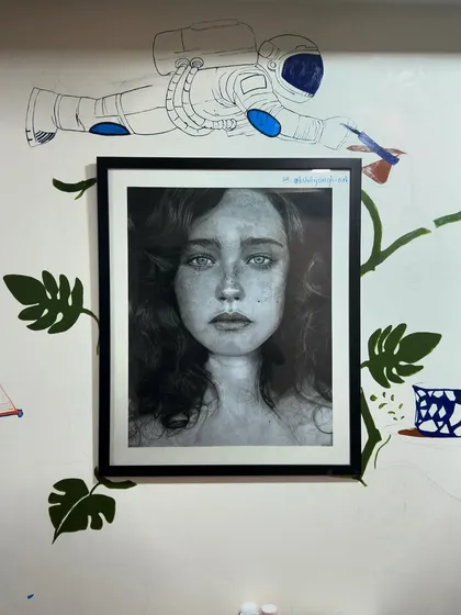 An update on my wall painting. You can see the mural developing around one of my favorite framed portraits. The astronaut and leaves are starting to come to life.