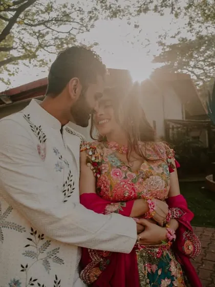 A sun-flared embrace. We love using the golden hour light to create a warm, dreamy glow around our couples, enhancing the romance of the moment.