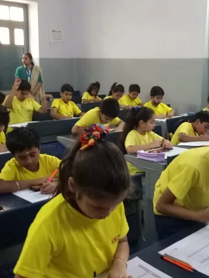 Students are hard at work, writing down answers with speed and precision during the competition. This is a test of both calculation and speed.
