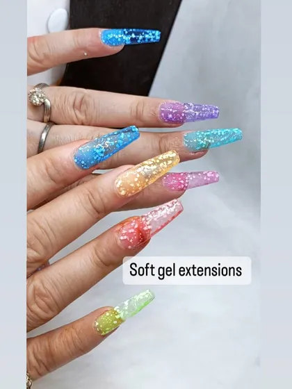 A vibrant and fun set of soft gel extensions. Each nail is a different color with encapsulated glitter, creating a playful "jelly" effect.