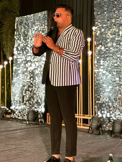 On stage in a unique black and white striped jacket. This modern, eye-catching piece is designed to stand out and keep all eyes on the host.