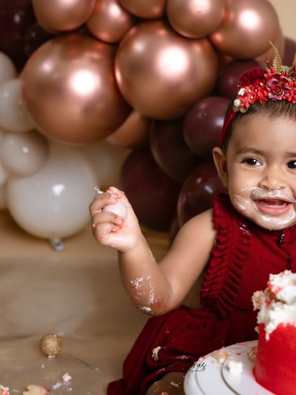 A happy, messy smile from the birthday girl during her stylish cake smash.
