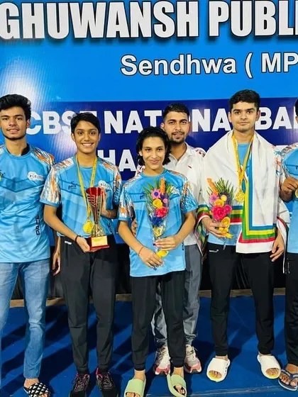 The victorious team at the CBSE National Badminton Championship in Sendhwa, MP. Alina Jain stands proudly with her teammates, showcasing the trophies and medals they fought hard for.