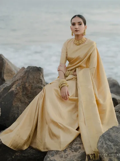 The stillness of the ocean meeting the grace of tradition. I directed this bridal portrait to capture the timeless elegance of a South Indian bride, styling her golden Kanjivaram saree against the rugged shoreline for a powerful, poetic contrast.