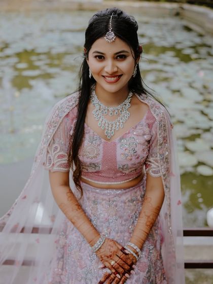 A stunning engagement look. The client's soft, elegant makeup and jewelry are perfectly complemented by the delicate henna on her hands.