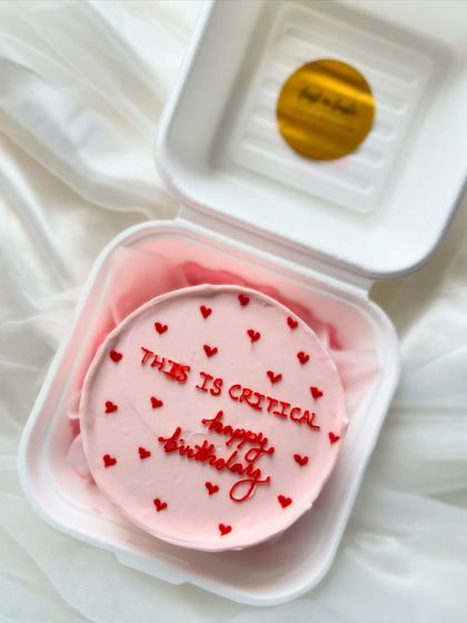 For when the birthday is a top priority. This pink bento cake with red hearts and the message "This is critical happy birthday" adds a touch of humor to the celebration.