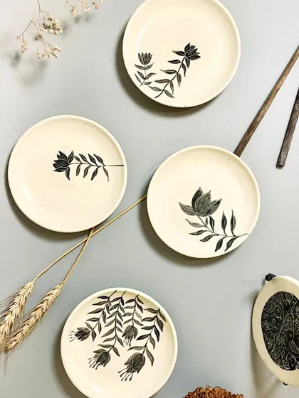 This set of four hand-painted quarter plates is perfect for appetizers or desserts. Each plate features a unique botanical design, bringing a touch of elegance and individuality to your table setting.