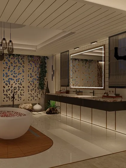 An evening view of the open-plan bathroom, where artificial lighting highlights the different textures and features. The backlit mirror and under-vanity lighting create a warm and inviting glow.