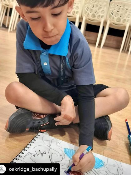A young student deeply focused on his artwork during our session. It's amazing to see kids express themselves so freely through art.