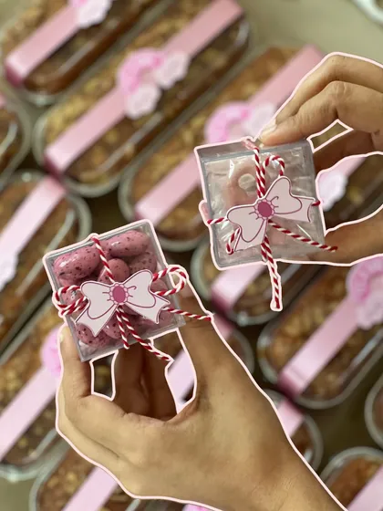 Tiny boxes of rose-flavored dragees, tied with baker's twine and a bow tag, were one of the sweet treats included in the announcement hampers.