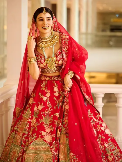 For this bridal campaign, the goal was to create a moment of pure joy. The vibrant red lehenga stands out against the elegant architecture, and the natural, happy expression of the model makes the entire scene feel authentic and aspirational for any bride-to-be.