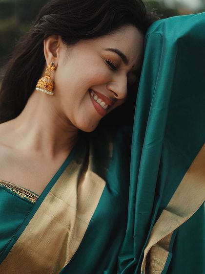 A close-up shot capturing Mirnalini's infectious smile. The focus is on her natural beauty, enhanced by a simple and fresh makeup look.
