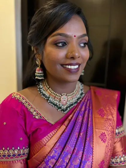 Priyanka smiling, showcasing her beautiful reception look. The airbrush makeup ensures a flawless finish that lasts all night.