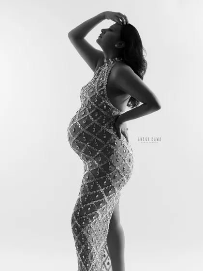 A powerful, high-contrast silhouette in black and white. This artistic shot emphasizes the strength and beauty of the pregnant form.