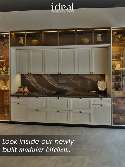This newly built modular kitchen at my experience center showcases a classic look with a modern twist. I used fluted cabinet doors and glass-fronted displays with internal lighting to create a sense of timeless elegance.
