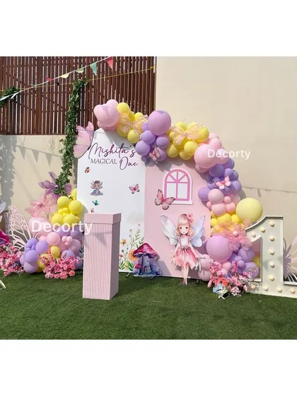 The complete fairy-themed backdrop with a light-up number one and butterfly wing props.