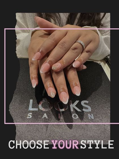 A full view of the hands, showing how a classic French manicure with a simple accent nail can create a cohesive and elegant look. It's a style that never fails to impress.