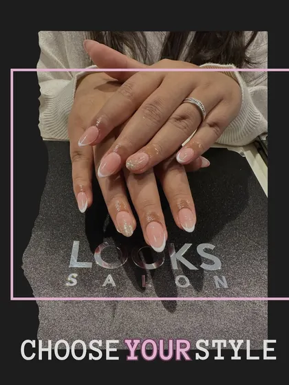 A full view of the hands, showing how a classic French manicure with a simple accent nail can create a cohesive and elegant look. It's a style that never fails to impress.
