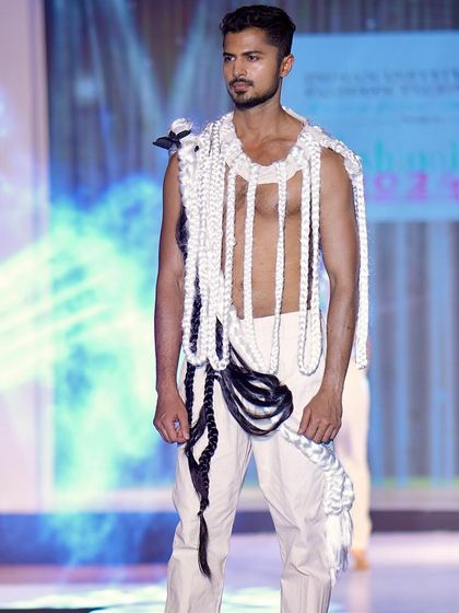 Showcasing an intricate, woven top on the runway. This piece highlights my physique while being a work of art in itself, perfect for high-concept fashion shows.