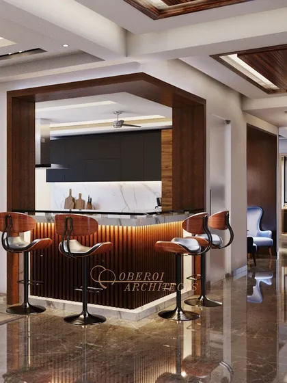 A stylish home bar and kitchen pass-through, featuring a backlit fluted wood base and modern bar stools, perfect for entertaining.