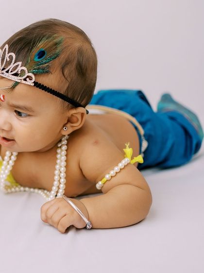 Another adorable pose from the Little Krishna session, capturing his innocent and playful spirit.