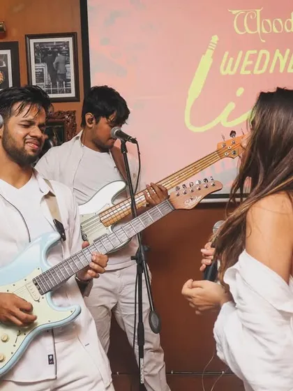 Our guitarist Joshua and vocalist Shanelle interacting on stage during our "all-white" themed gig at Woodside Inn. The chemistry between us is what makes our shows so much fun.