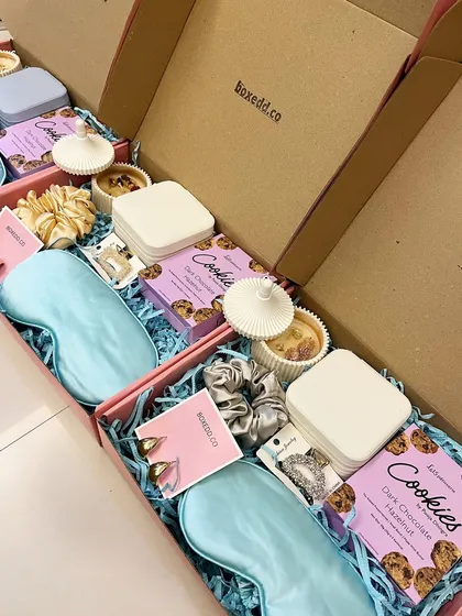 These bridesmaid hampers were curated for a bridal shower, including silk eye masks, cookies, scented candles, and other pampering goodies.