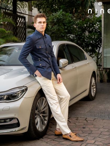 The Hunter's Safari Jacket in navy blue, crafted from a linen, silk, and wool blend. It's a versatile, multi-pocketed jacket that is both functional and incredibly stylish.