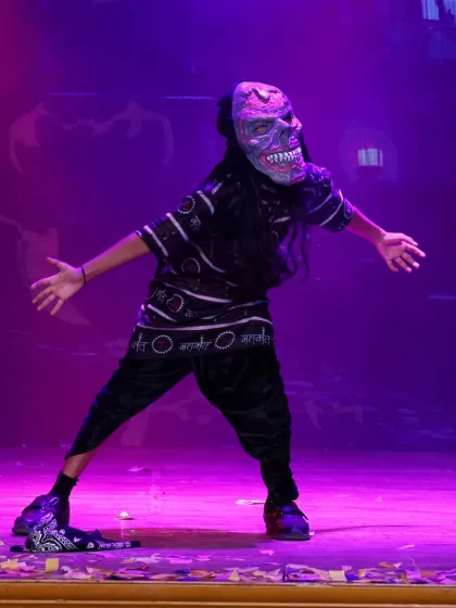Our performances often feature unique concepts and costumes, like this spooky character from a themed dance piece. We encourage students to explore different characters and performance styles.