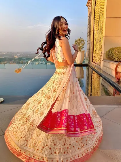 A radiant wedding guest look, perfected for a stunning rooftop celebration. We created soft, flowing curls and a glowing makeup finish to complement her beautiful lehenga, ensuring she felt confident and joyful throughout the event.