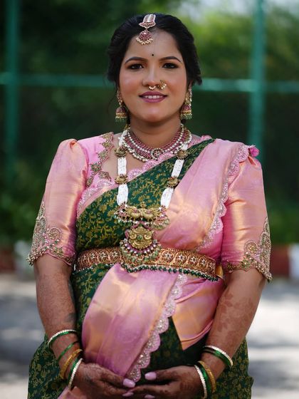 A full view of the traditional attire for the Seemantham. The makeup, hair, and saree draping all come together to create a complete and regal look.