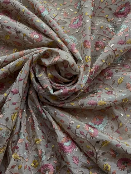 The same exquisite embroidered tissue fabric, shown here with a swirl that highlights its beautiful drape and the density of the floral embroidery.