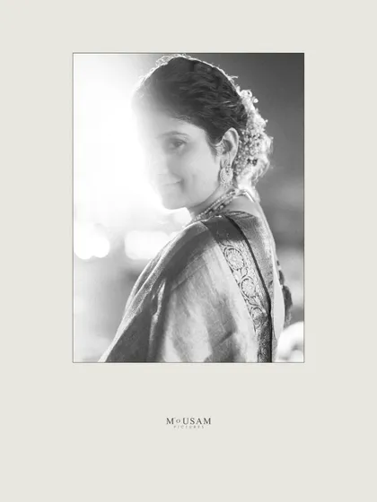An artistic black and white bridal portrait. The strong backlight creates a beautiful silhouette effect, while she gives a subtle glance towards the camera. It’s a simple, yet powerful and magical frame.