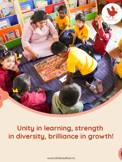 A teacher and a small group of students gather on the floor, deeply engaged in a hands-on literacy game. This demonstrates our commitment to small batch sizes and interactive learning, ensuring no child gets lost in the crowd.
