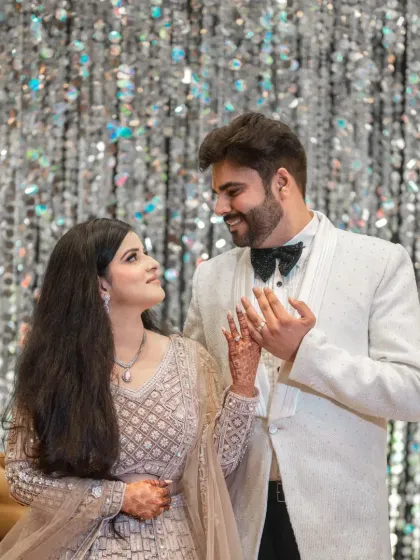 A sweet, candid moment between the couple, sharing a look of love and happiness after their engagement.