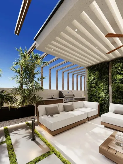 A close-up of the covered seating area, which includes an outdoor barbecue and counter space, making it a fully functional spot for cooking and dining.